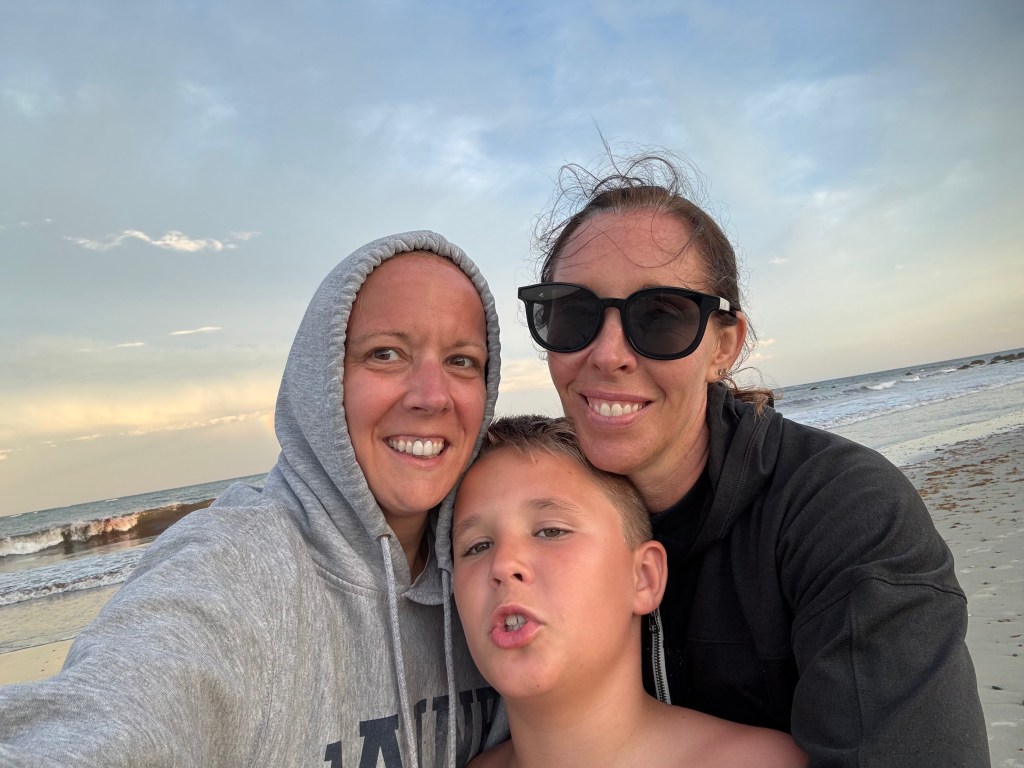 Henry and two Kates in front of a rainbow